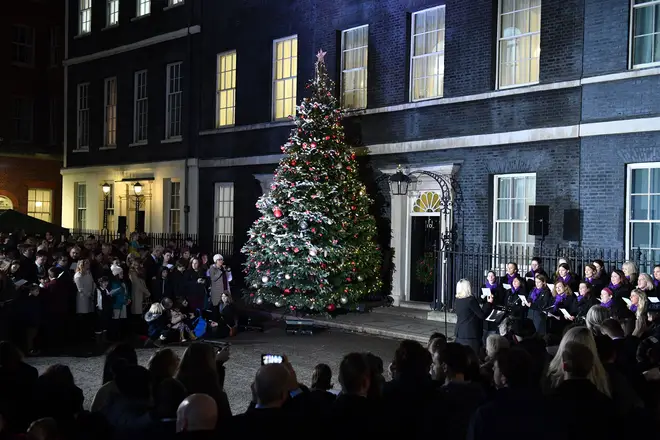 Carol singers sing outside No. 10 Downing Street in London England