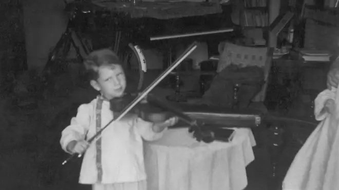 André Rieu playing a full-size violin as a child