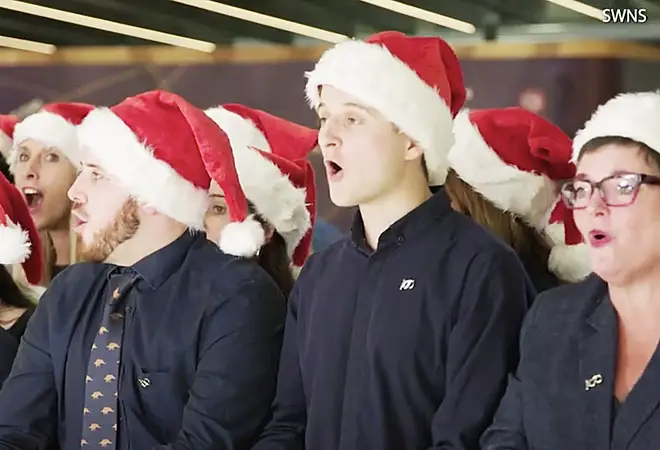 The crew sang ‘Deck the Halls’ to surprised onlookers in Terminal 5