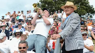 Geoffrey Boycott listens to ‘Barmy Army’ trumpeter Billy Cooper during a New Zealand and England test match