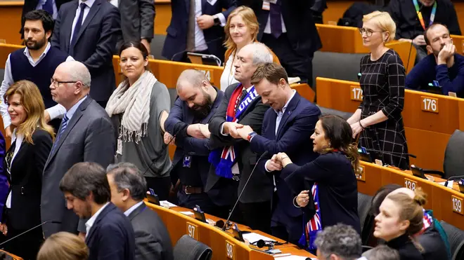 MEPs hold hands after European Parliament vote in Brussels on January 29, 2020