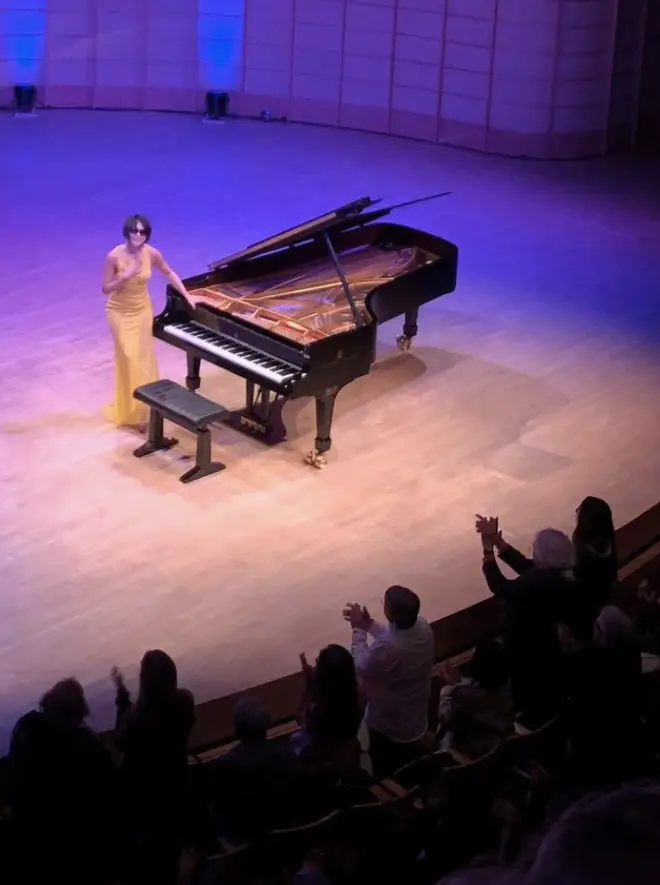 Yuja Wang, in sunglasses, pictured smiling at audience