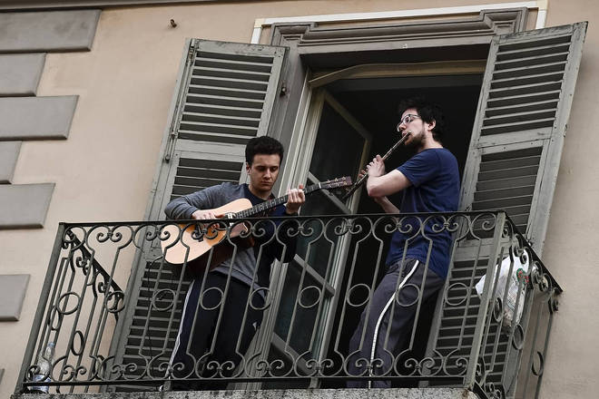 Quarantined musicians play and sing from balconies in locked-down Italy