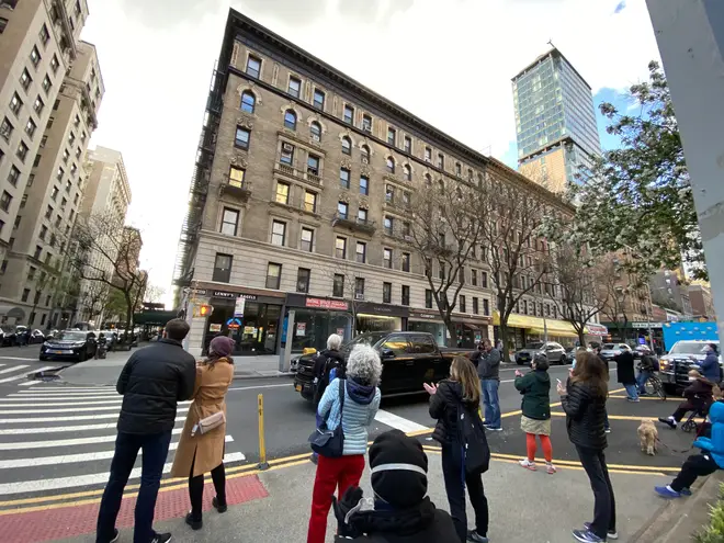 People gather in the streets below the actor's apartment to hear him sing