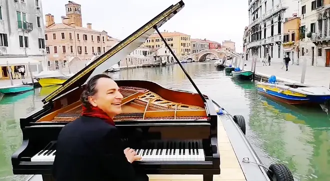 A pianist took his grand piano on a barge, to serenade the canals of Venice
