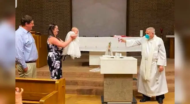 The story behind the viral image of a baby being baptised by a priest with a water gun