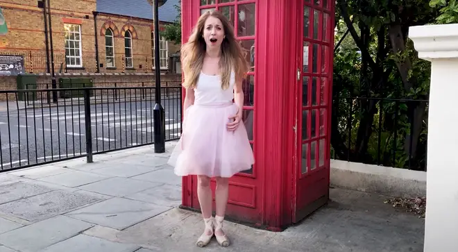 Ballerina sings along to The Rolling Stones outside a traditional British phone box