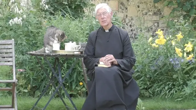 Cat drinks from milk jug during online sermon