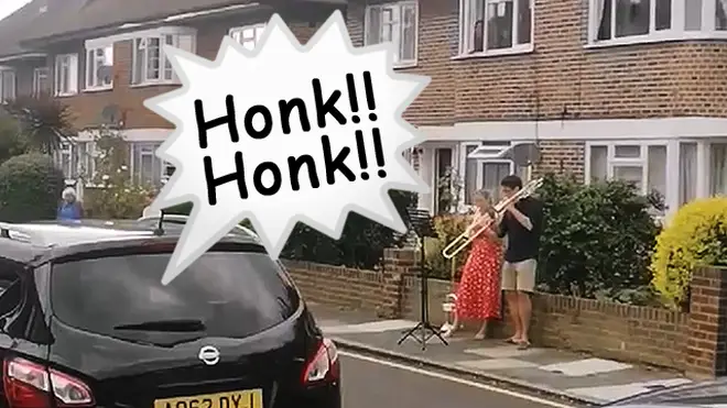 Couple’s neighbourhood brass duet turns into waltz trio, as car horn joins in