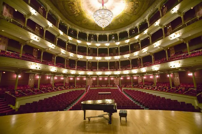 Piano in an empty concert hall