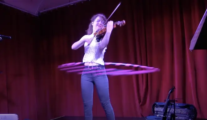 Violinist plays Paganini while hula-hooping