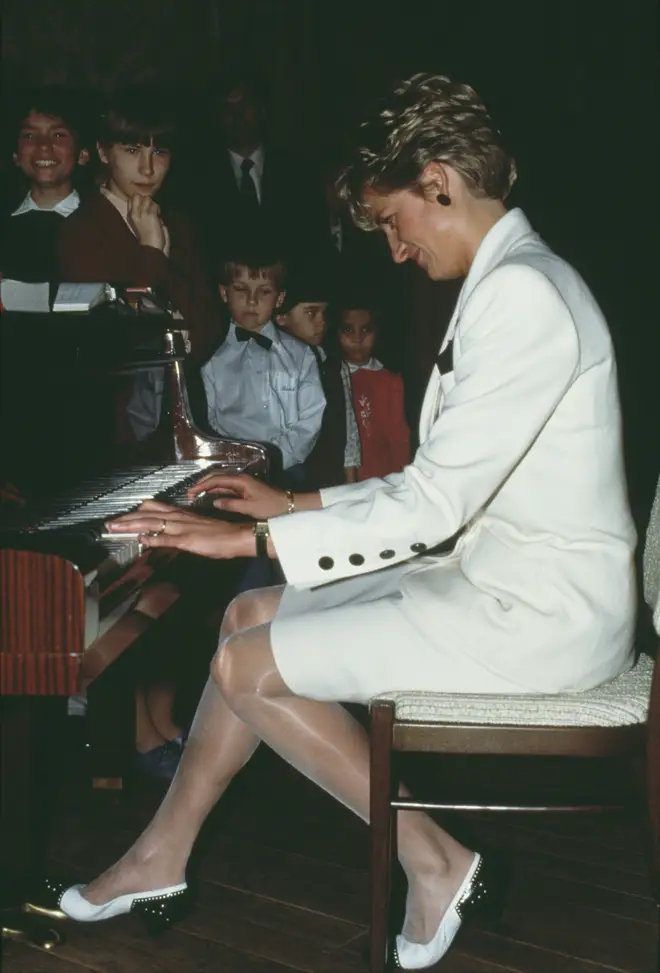 Diana, Princess of Wales plays piano during a 1991 tour in Prague