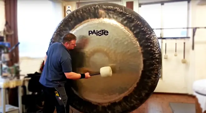 Man plays a mighty 80-inch symphonic gong