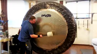 Man plays a mighty 80-inch symphonic gong