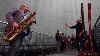 Baritone sax and overtone flute improvise duet in giant cooling tower