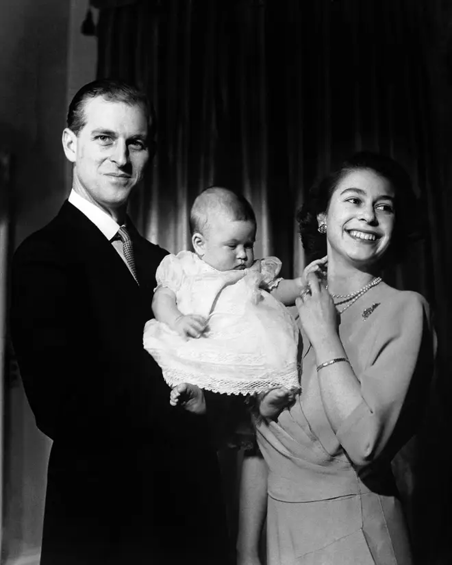 Princess Elizabeth and the Duke of Edinburgh hold their first child Prince Charles, aged 6 months.