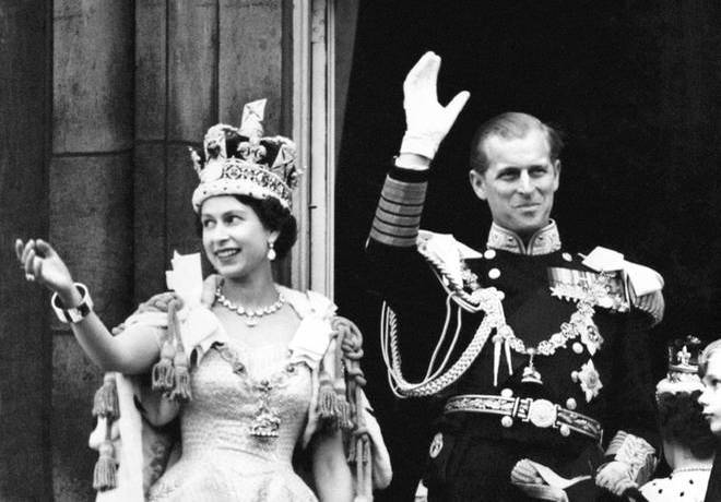 Queen Elizabeth II and The Duke of Edinburgh wave from the balcony to crowds around Buckingham Palace after the Coronation
