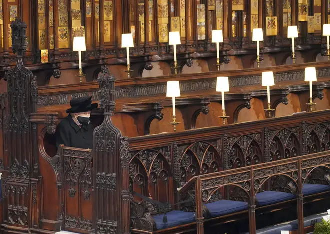 The Queen sits alone during the funeral of Prince Philip at St. George’s Chapel