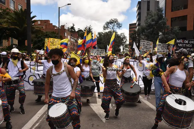 People march and play music in protest against the government in Bogota