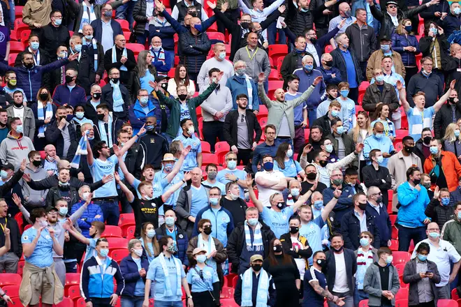 Manchester City fans sing in full voice at Wembley Stadium on April 25, 2021 in London, England