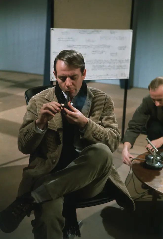 German composer Karlheinz Stockhausen smokes a pipe during a recording session