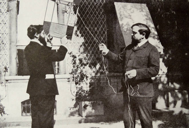Claude Debussy flying a kite with Louis Laloy.