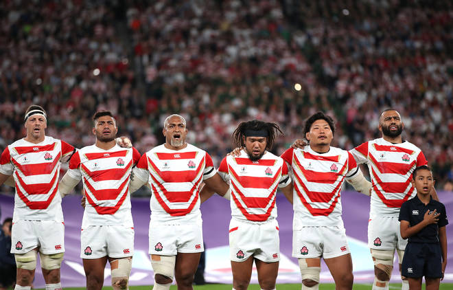 Japan players sing the national anthem prior to the Rugby World Cup 2019 at the Tokyo Stadium