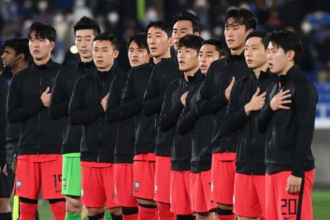 South Korea's players sing the national anthem prior to a friendly football match with Japan