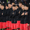 South Korea's players sing the national anthem prior to a friendly football match with Japan