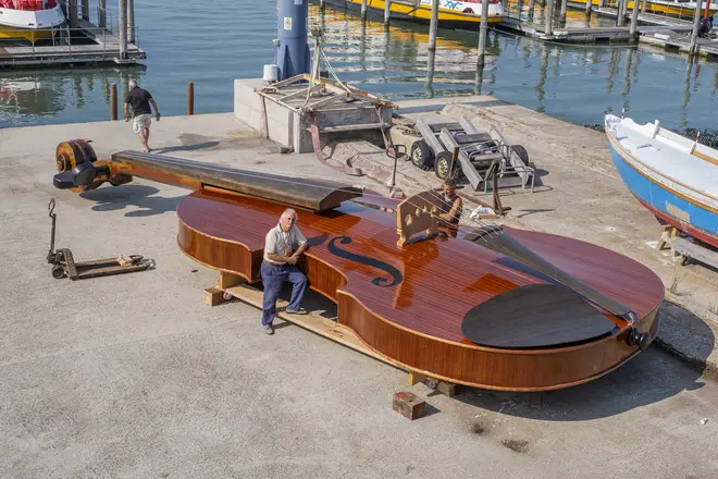 Artist Livio De Marchi poses next to his latest creation