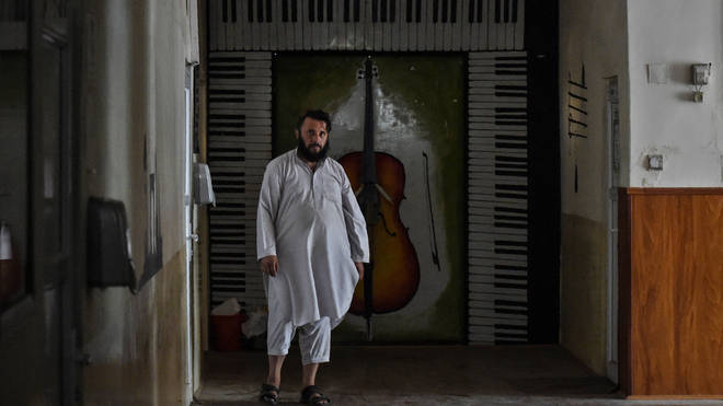 A member of the Taliban walks in a corridor at the Afghanistan National Institute of Music in Kabul.