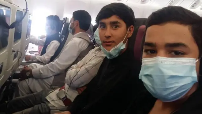 Students from the Afghanistan National Institute of Music on a plane to Doha