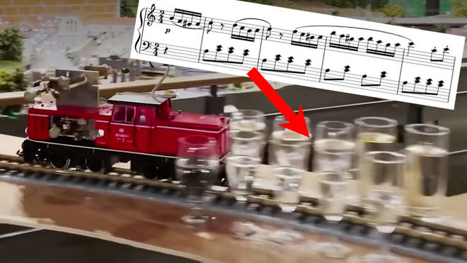 Tiny model train breaks a world record by playing epic classical medley on passing glasses