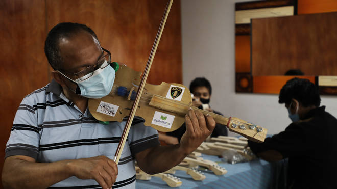 Jesús Peralta makes the violins out of recycled materials