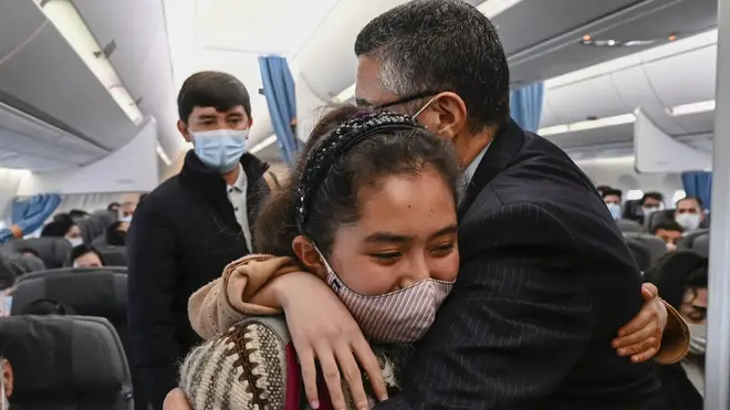 A student of the Afghanistan National Institute Of Music is embraced after landing in Lisbon, Portugal