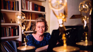 Angela Morley pictured at the piano with her awards