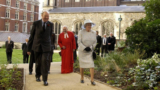 Sir Michael Bunbury of the Duchy of Lancaster and Her Majesty Yhe Queen the gardens of the Queen's Chapel of the Savoy in London, 2003.