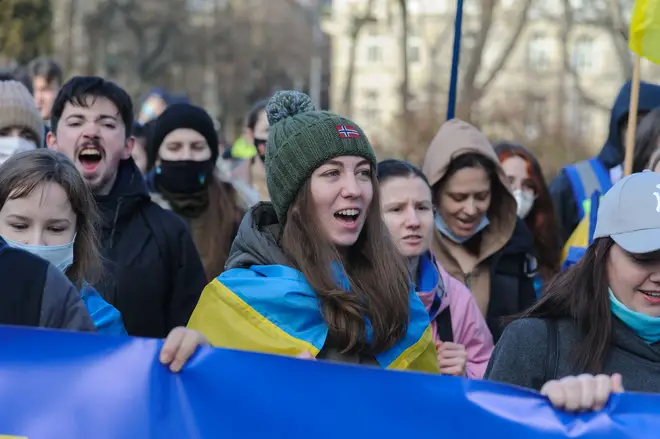 Ukrainians sing national anthem during the Unity March for Ukraine in downtown Lviv on 19 February