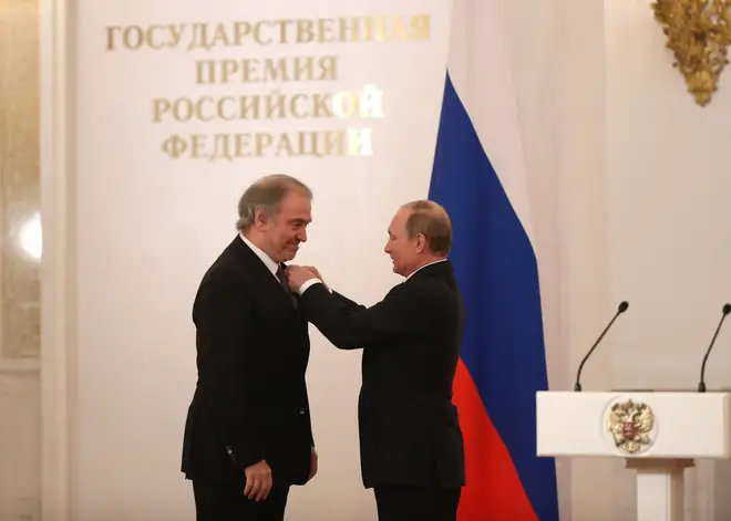 Russian President Vladimir Putin greets conductor Valery Gergiev during the awarding ceremony at the Grand Kremlin Palace.