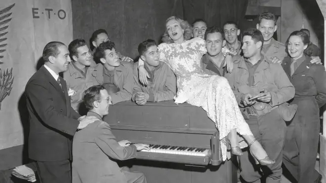 Actress Marlene Dietrich singing for a group of GI's in France