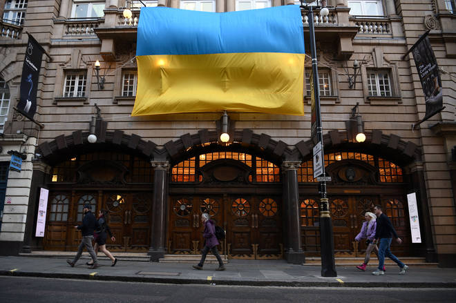A Ukrainian flag hangs from the facade of the London Coliseum