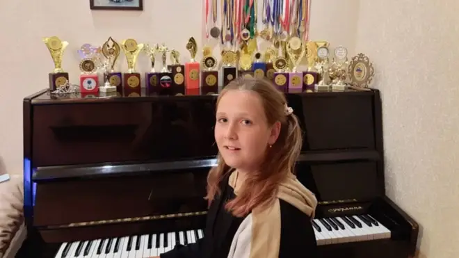 Darynka at the piano with her many awards