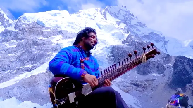 Mand performs for a crowd of climbers at Everest Base Camp