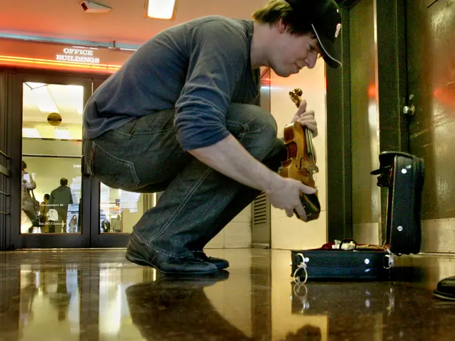 Joshua Bell sets up his violin at L'Enfant Plaza Metro, in Washington, DC