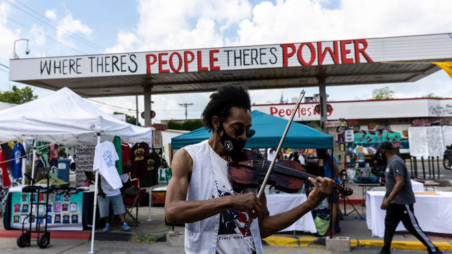Raycurt Johnson plays a violin on the first anniversary of the murder of George Floyd, at George Floyd Memorial Square in Minneapolis, Minnesota