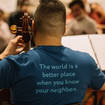 CAYO message in action on the back of cellist Omar Macias, May 2022 Residency