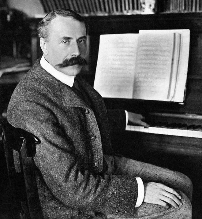 Former Master of the King’s Music, Edward Elgar, sits at his piano.