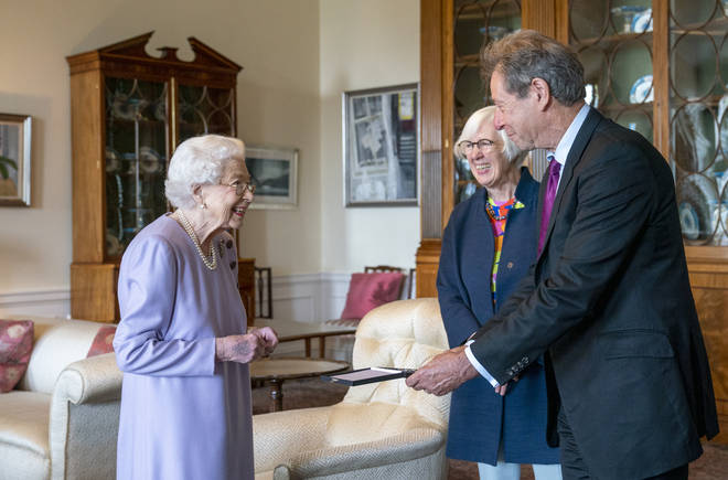 Queen Elizabeth II honors trumpeter John Wallace CBE with the 2021 Queen's Order of Music, accompanied by Judith Weir.