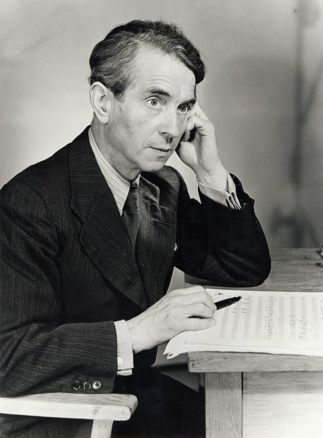 English composer Herbert Howells, pictured working on a score in July 1947.