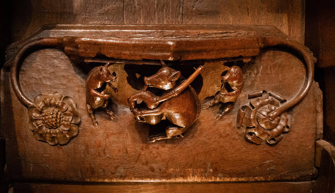 Three dancing pigs are carved into an oak misericord in Ripon Cathedral, Yorkshire, one of which is playing the bagpipes.